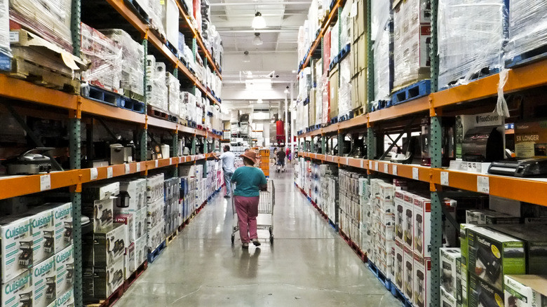 Woman walking down Costco aisle