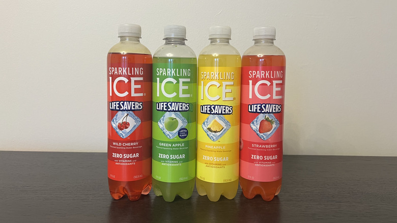Four different Sparkling Ice Life Savers flavors in bottles.