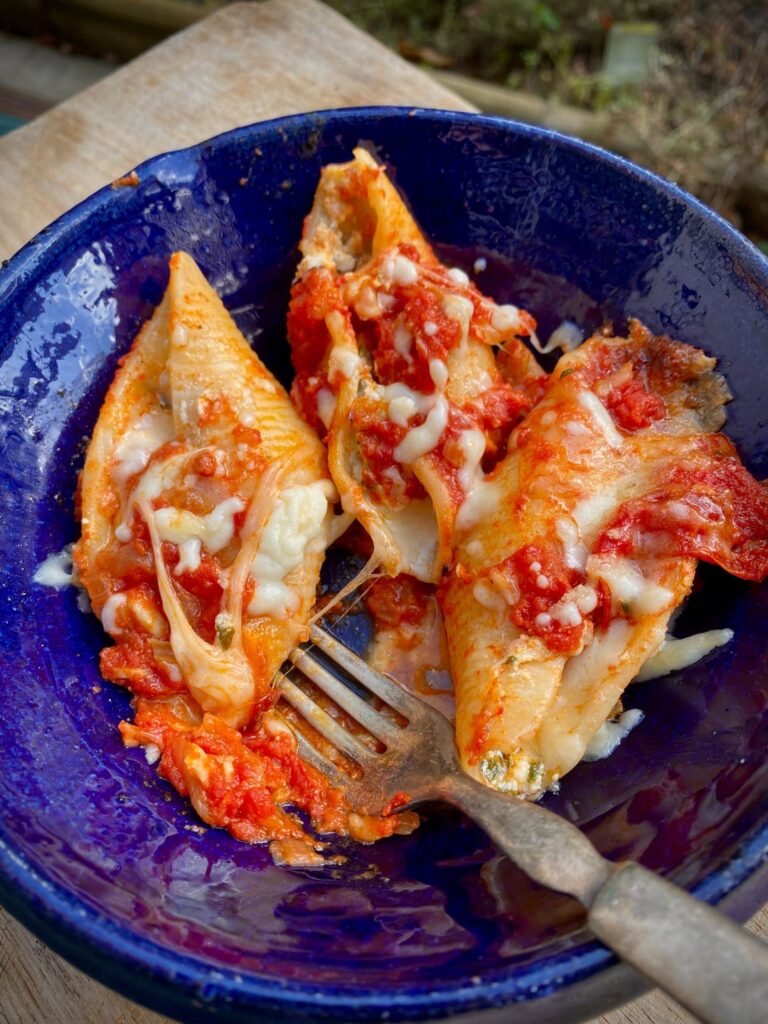 Stuffed shells with ricotta, spinach, tomato basil sauce, and mozzarella cheese