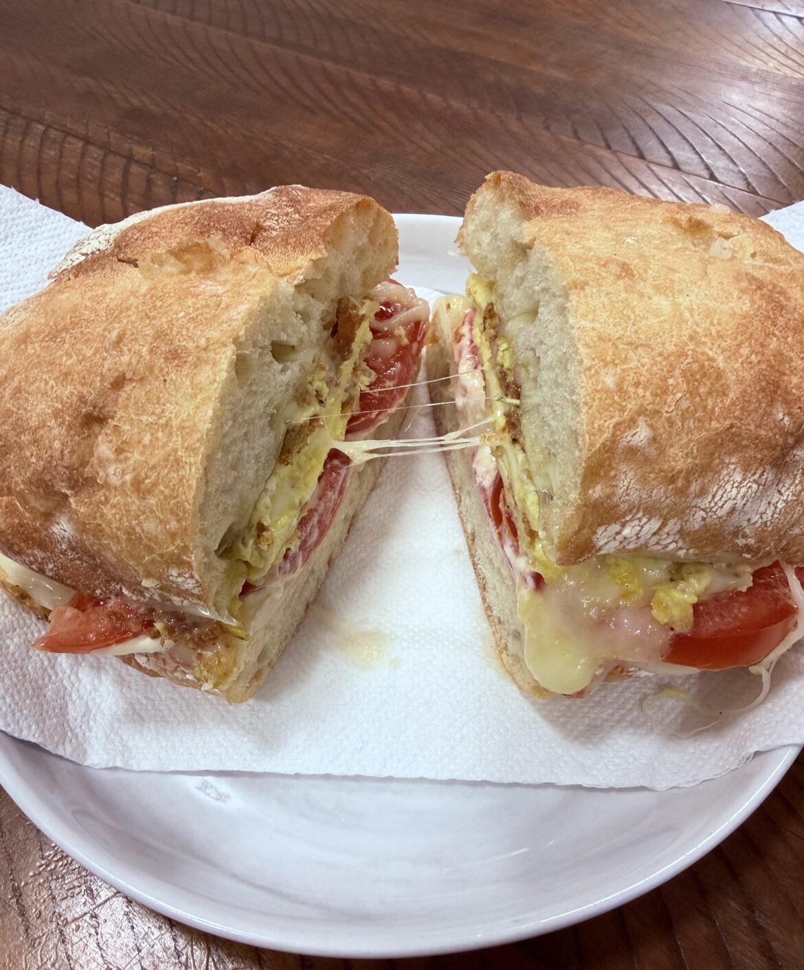 Scrambled Eggs, Swiss Cheese, Turkish CheChel Cheese, Garden Tomatoes, Olive Oil, Mayo, and Rosemary on Ciabatta