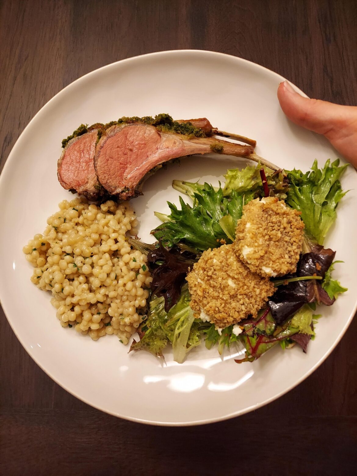 Herb-dijon crusted rack of lamb, lemon-herb couscous, and spring salad with goat cheese medallions