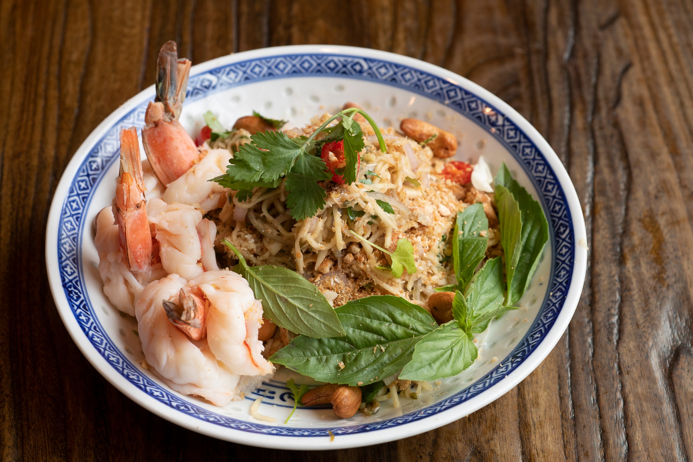bowl of thai noodles, basil, and shrimp