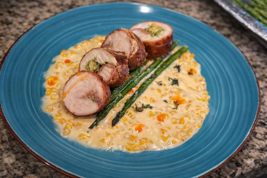 [homemade] Sous vide chicken roulade, wrapped with prosciutto, filled with pesto, sear finished in cast iron pan. Served with corn supreme sauce, grilled asparagus and a few drops of chili oil