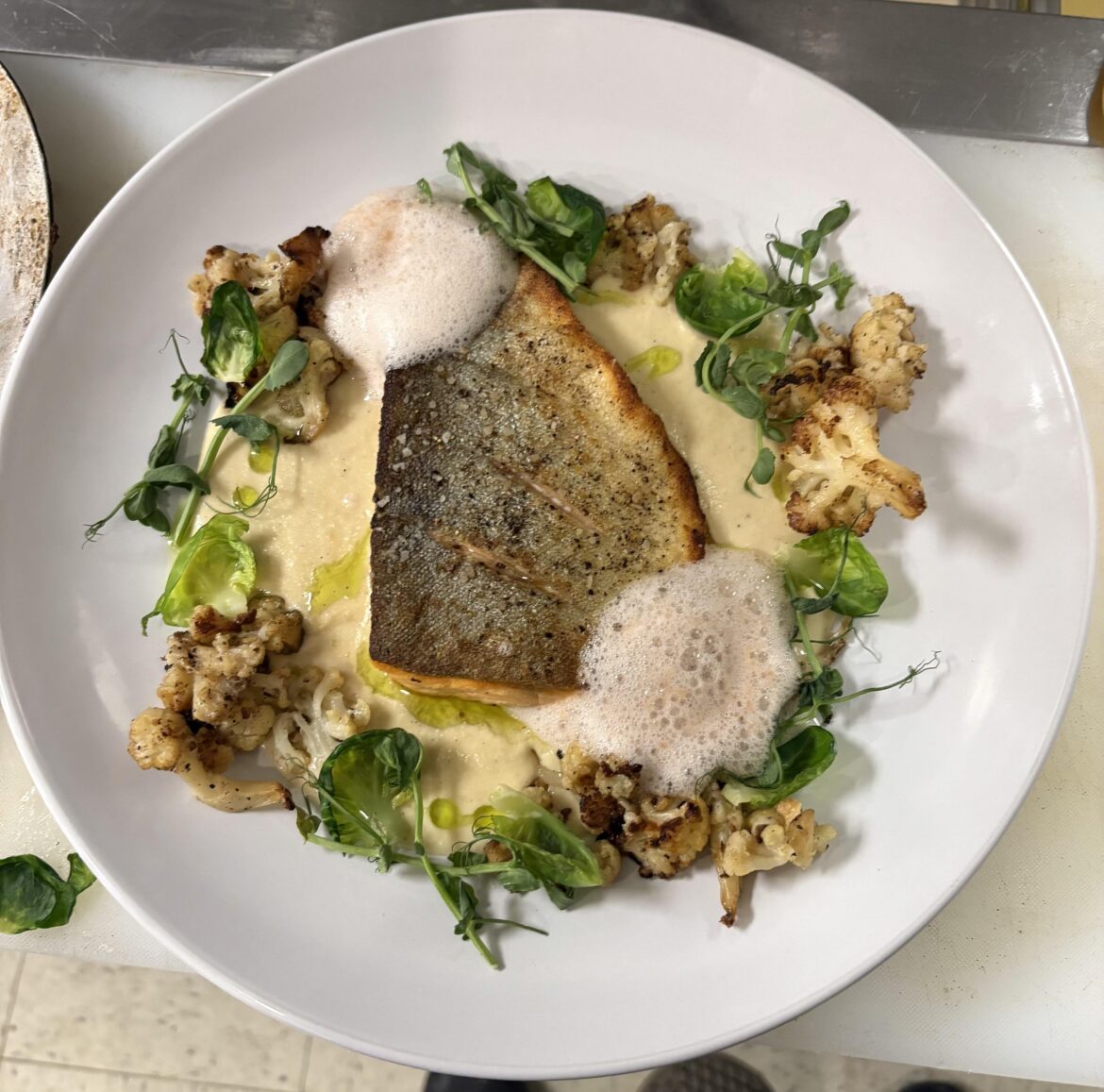 Crispy skin Arctic Char: onion soubise, cauliflower, brussel sprout, pea tendril, lavender/apple foam, basil oil