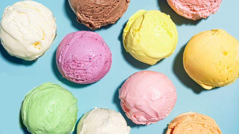 Colorful scoops of ice cream against blue background