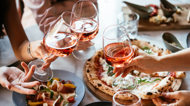People holding wine glasses at an Italian restaurant