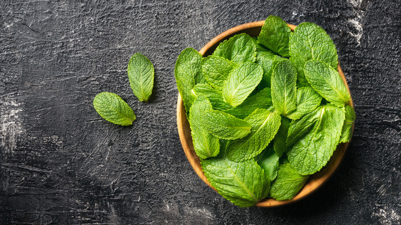 Wooden bowl of fresh mint leaves