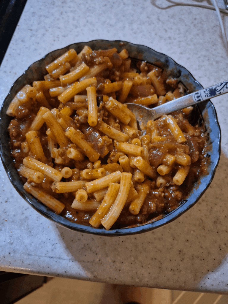 Rate my pasta. Ground beef and red onion are in the pasta sauce
