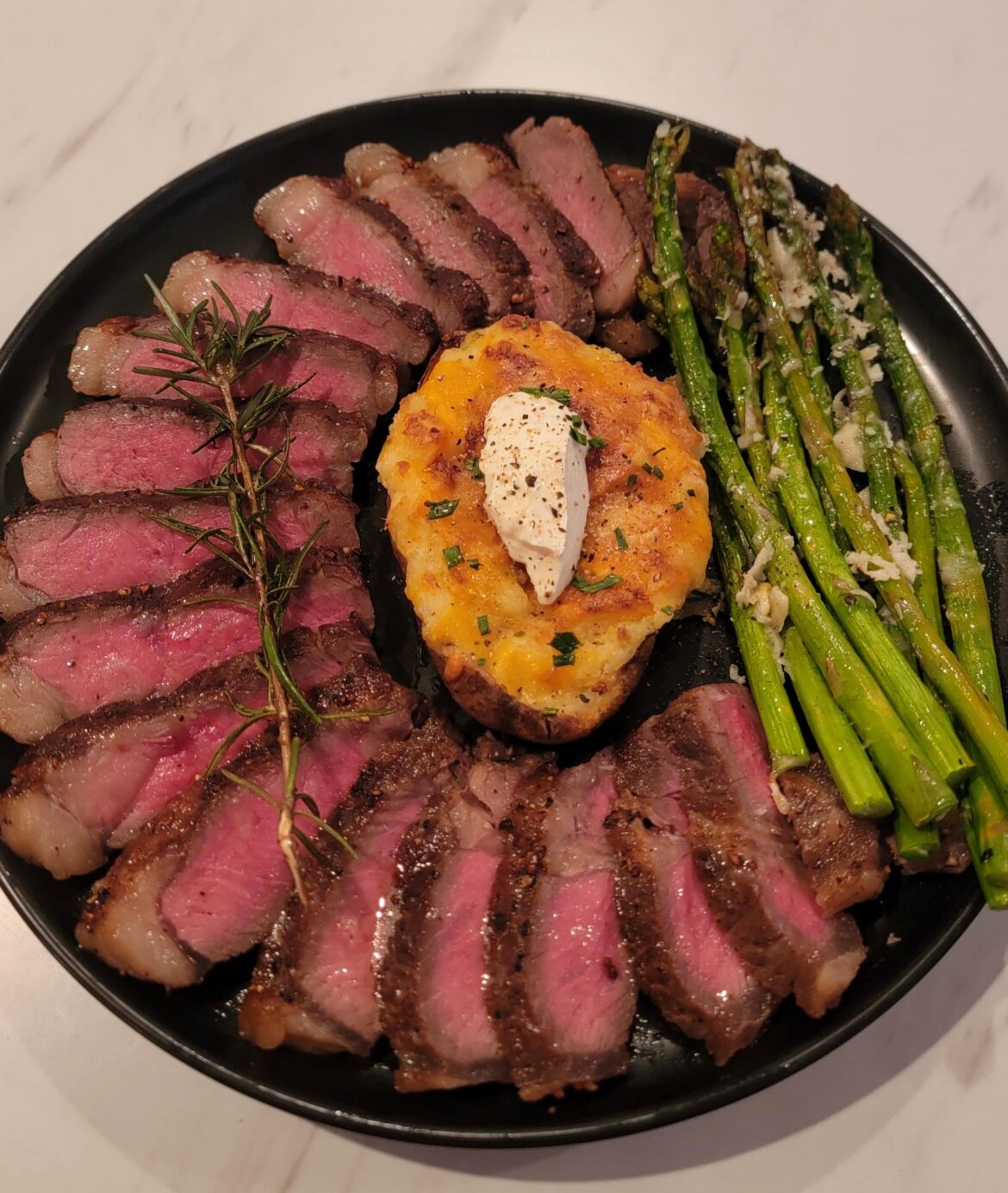Homemade Prime New York Steak With Twice-Baked Potato and Asparagus