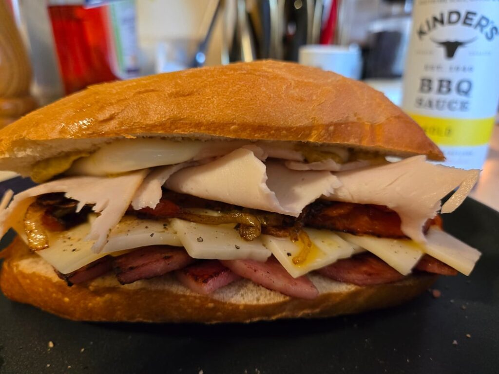 Taylor Ham/ Pork Roll with turkey, Swiss, roasted onions/peppers, mustard, mayo.