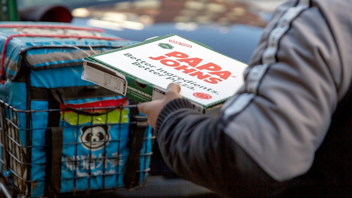 A Papa Johns pizza is being delivered.