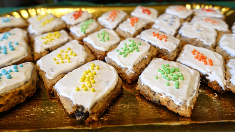 A tray of papassini sardi cookies with rainbow sprinkles