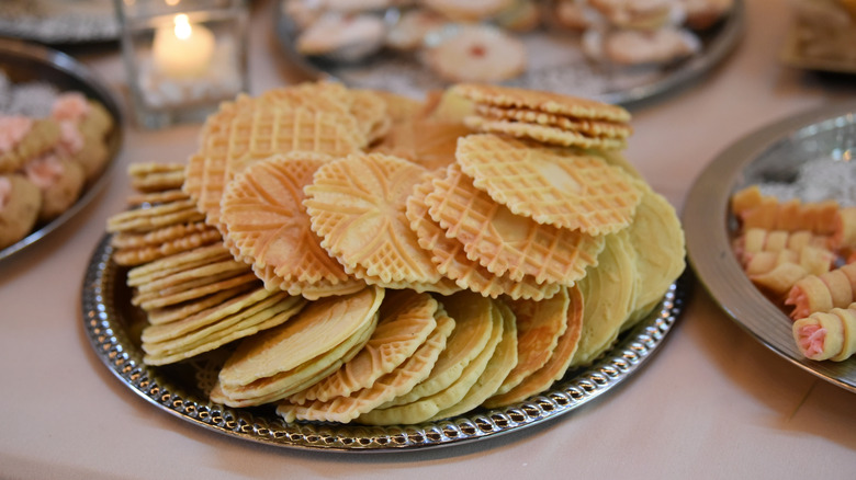 A plate of pizzelle dipped in pistachio cream