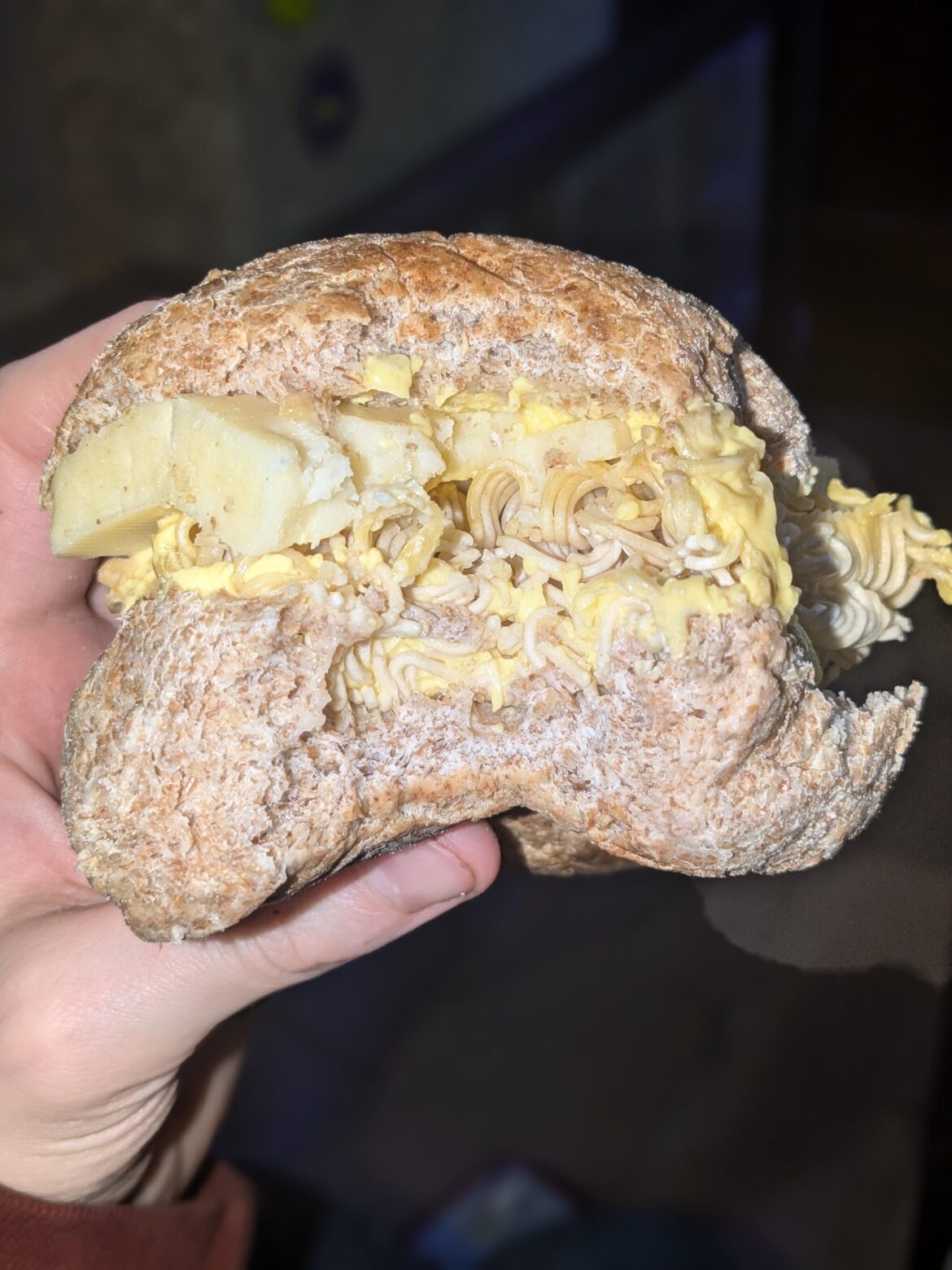 Uncooked chicken noodles in a wholemeal bun with cheese and too much margarine