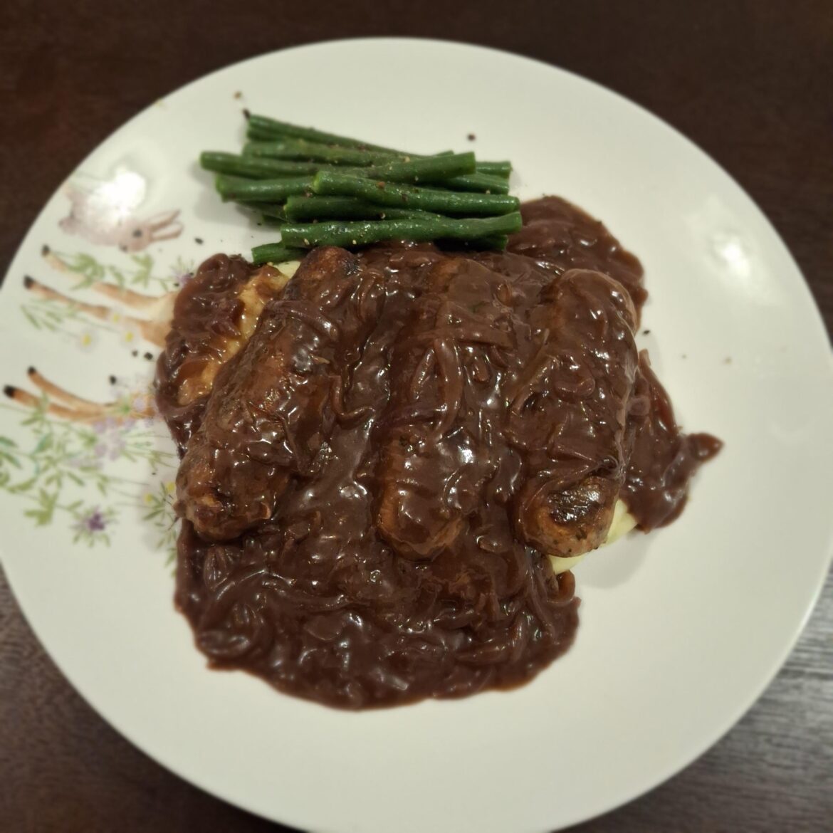 Bangers & mash with red wine onion gravy and a few green beans.