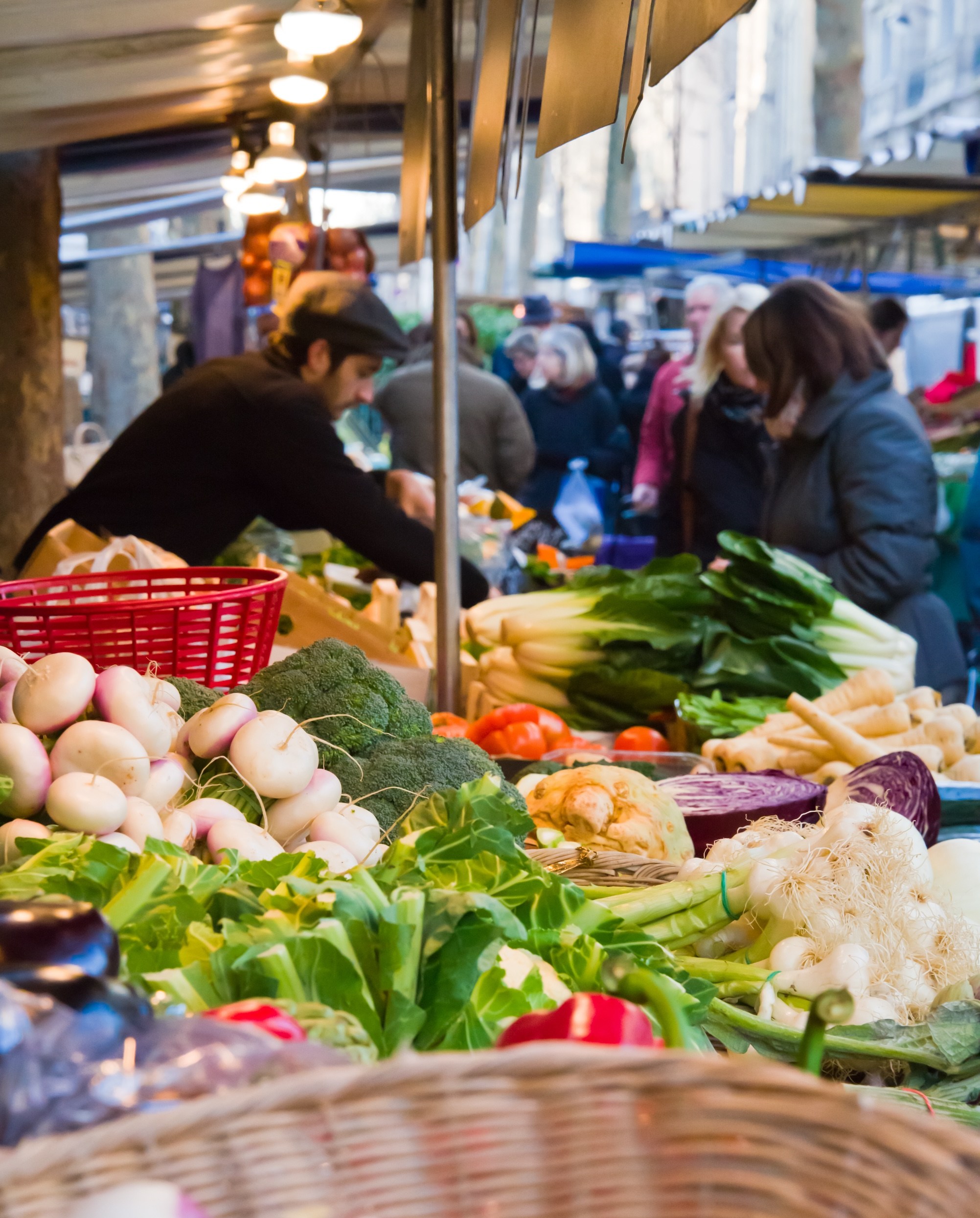 Shoppers at an outdoor produce stand.