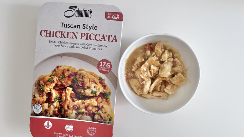Sabatino's Tuscan style chicken piccata in a bowl next to the paper package