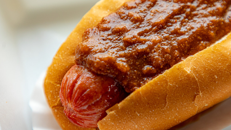 Hotdog topped with meat 