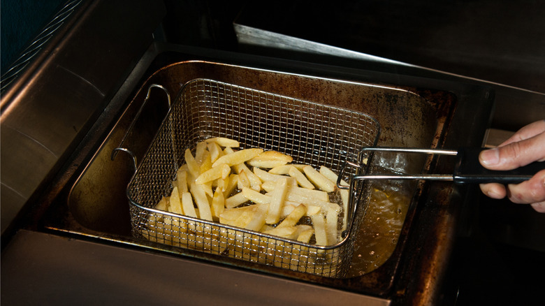 Deep fryer baskets full of french fries