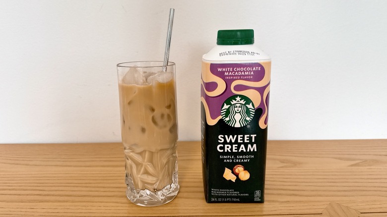 Starbucks White Chocolate Macadamia Inspired Sweet Cream Enhancer in a bottle and glass of iced coffee