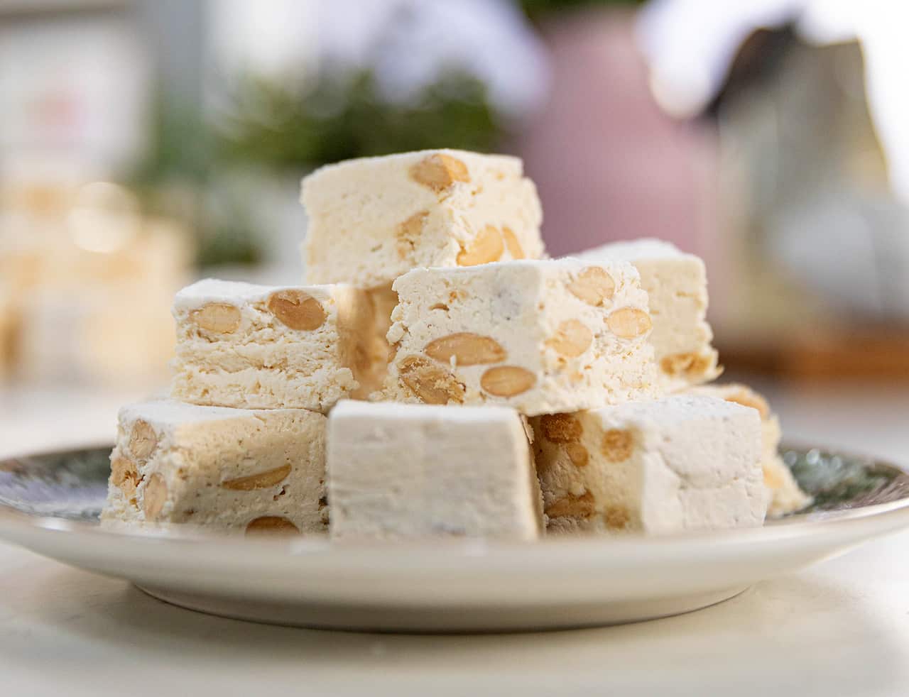 A stack of nougat pieces sit on a round plate.