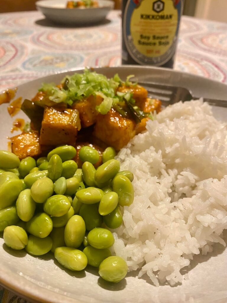 Pan Fried Corn Starch Coated Tofu in a White Pepper Sriracha Maple Syrup Sauce.