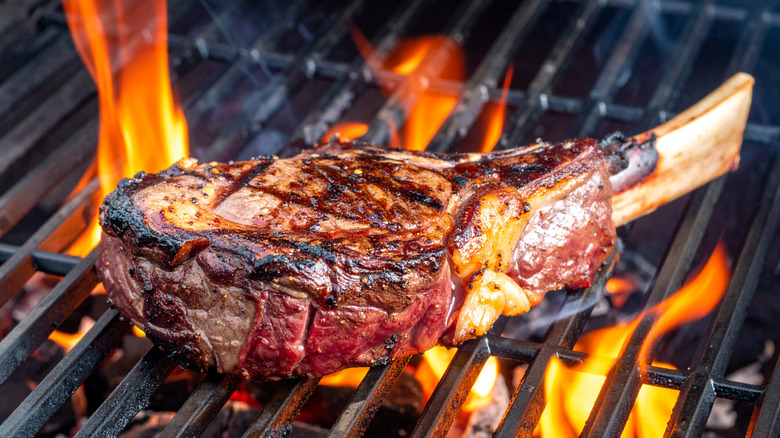 Steak grilling over open flame