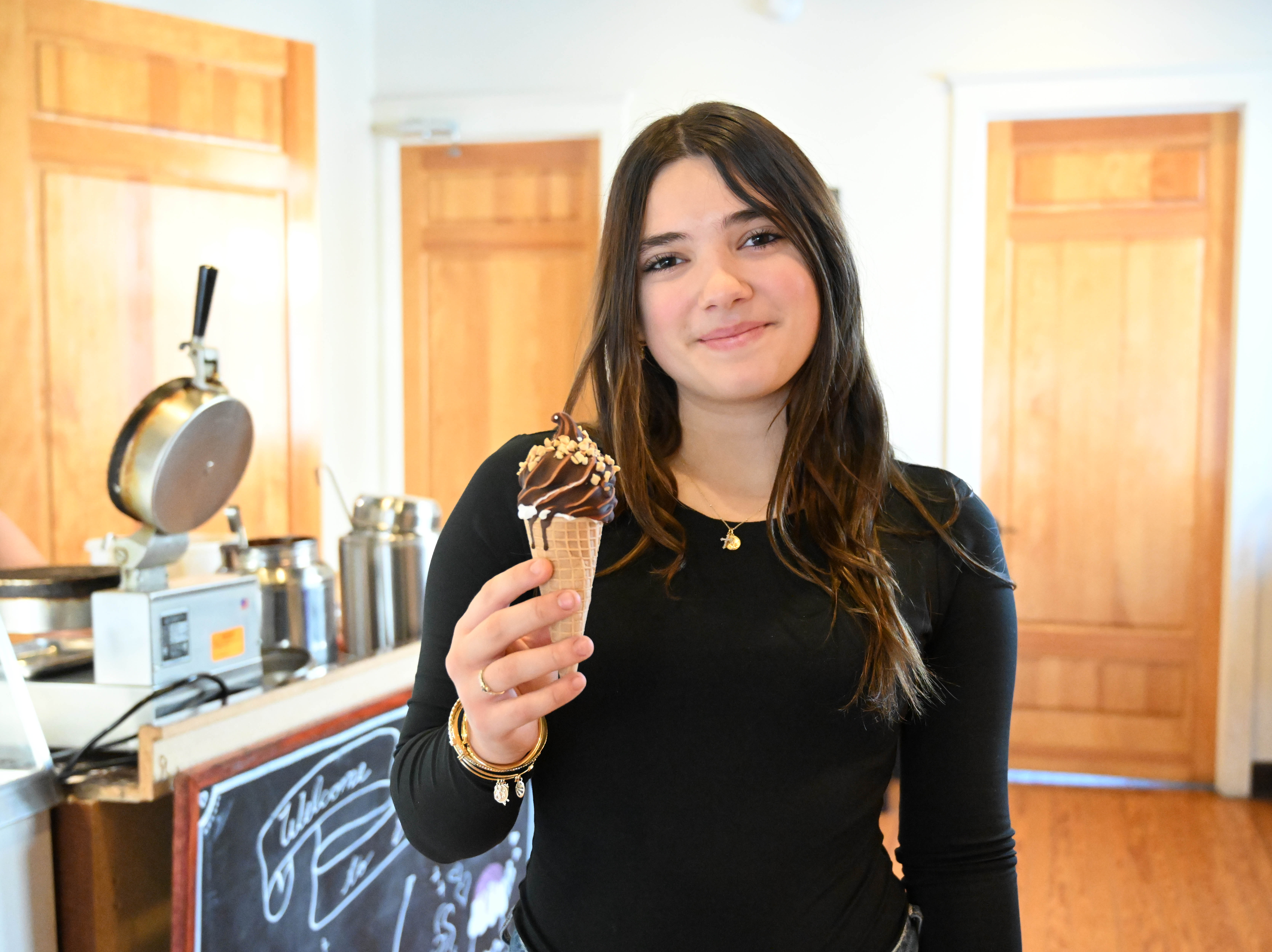 New Emily’s Ice Cream staff member Autumn Quercia holds an...