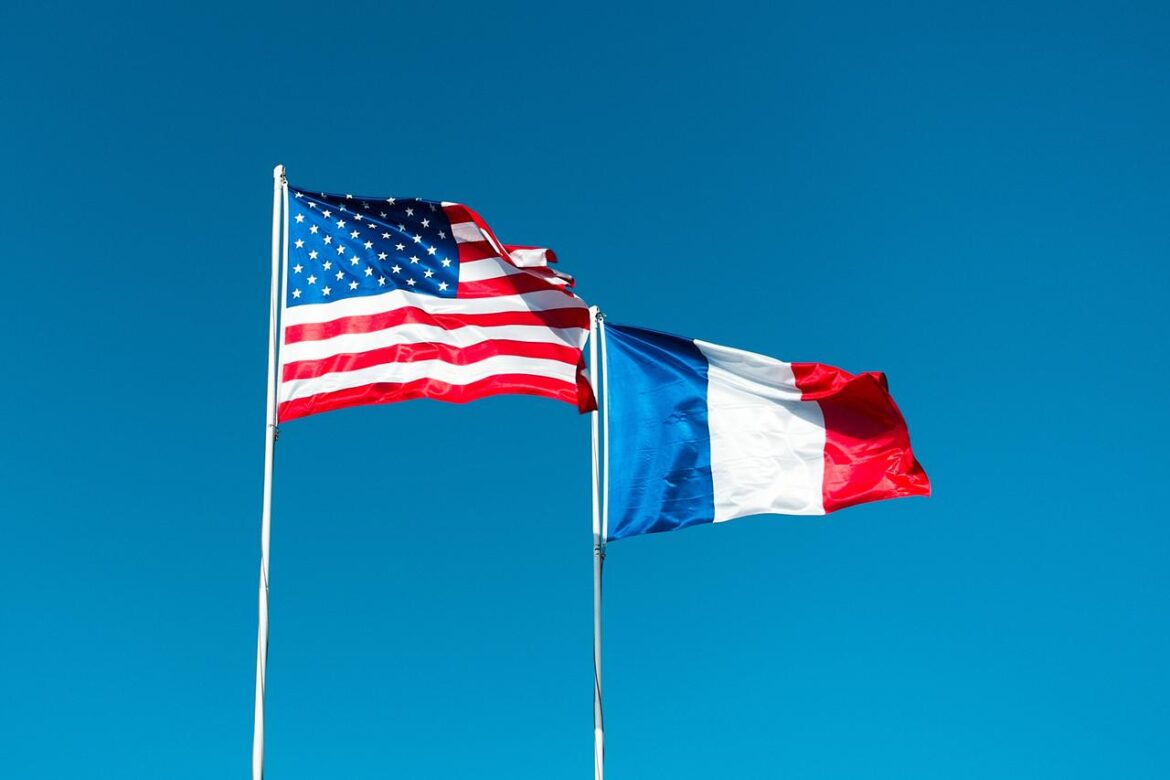 Flags of the United States and France fly side by side. (Adobe Stock Photo)