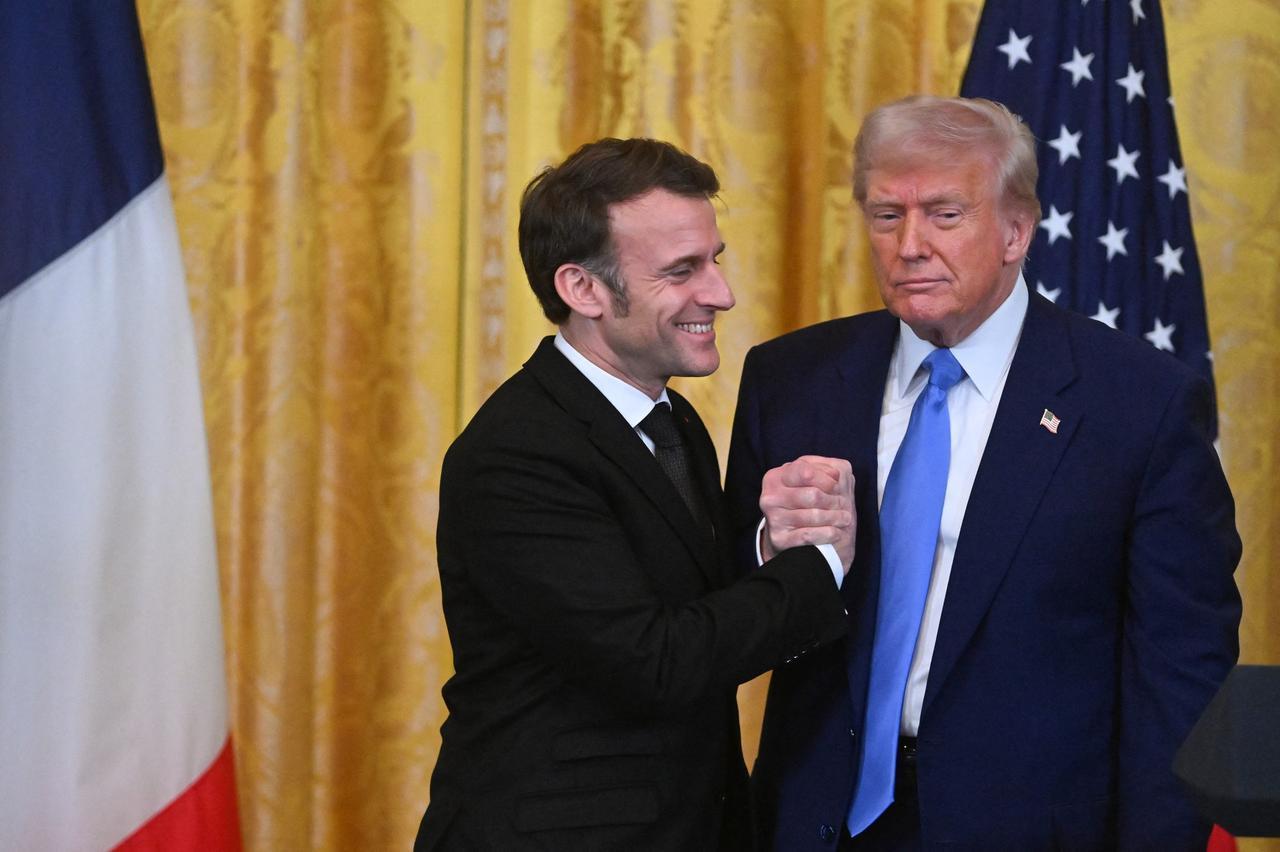 U.S. President Donald Trump (R) and French President Emmanuel Macron (L) shake hands during a joint press conference in the East Room to the White House in Washington, United States, Feb. 24, 2025. (AFP Photo)
