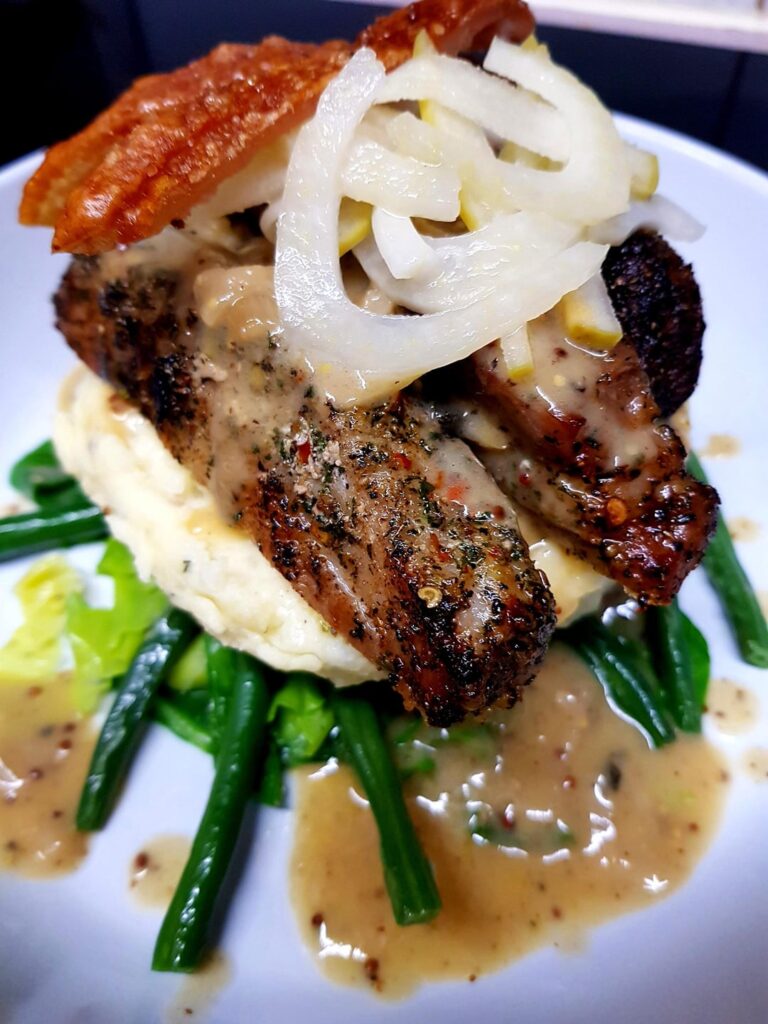 Marinated, Seared Pork Belly with Sour Cream Herb Mash, Sautéed Greens, Creamy Mustard, Cider Sauce and Light Pickled Fennel and Apple. My Own Recipe.