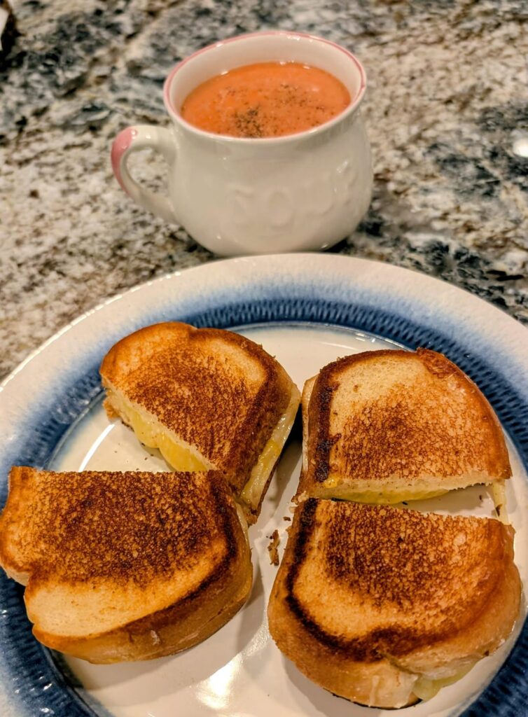 White Vermont Cheddar and Colby Jack on Artisano with tomato soup on a nippy night