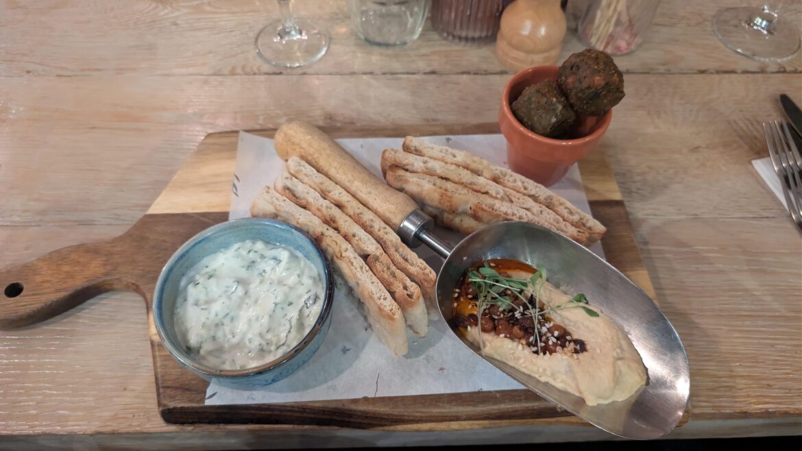 Mezze board with hummus in a spade and falafel in a plant lot
