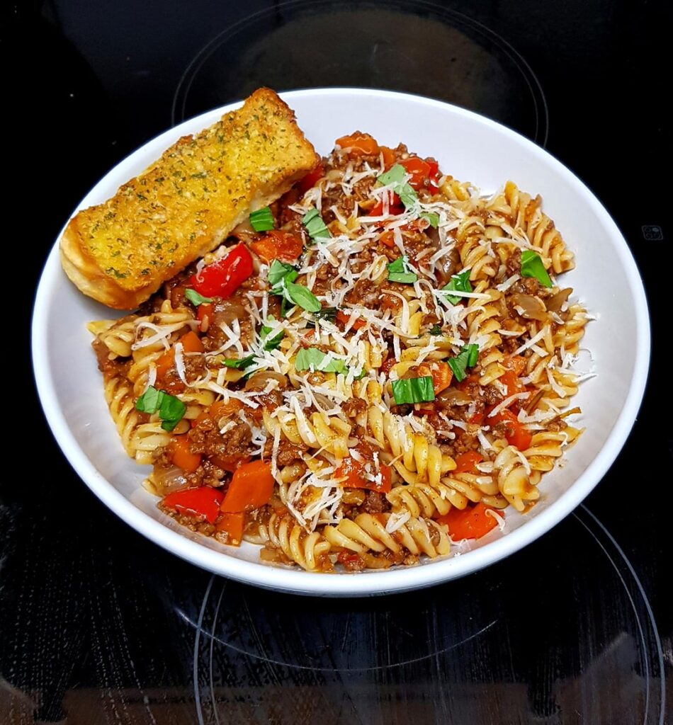 Beef Bolognese with Fusilli. Red Pepper Needed Using, So That Went in Too. Finished with Fresh Basil and Parmesan.