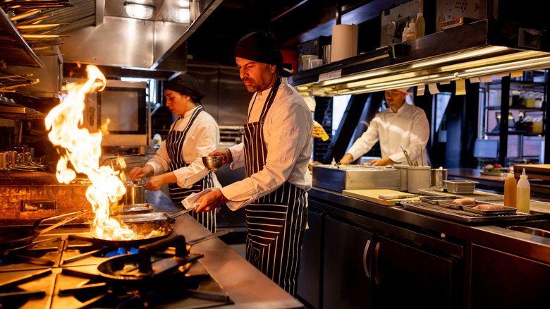 Cooks working in a busy restaurant kitchen