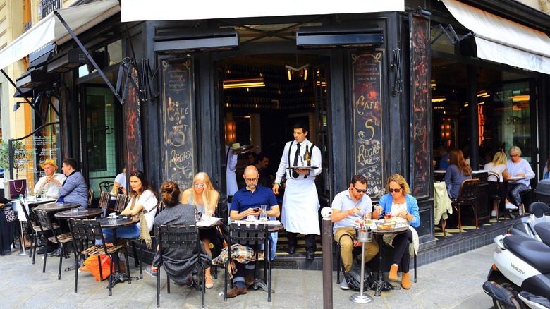 Entrance to a French cafe with outdoor seating