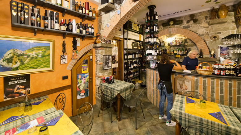 Interior of an enoteca with tables and wine shelves