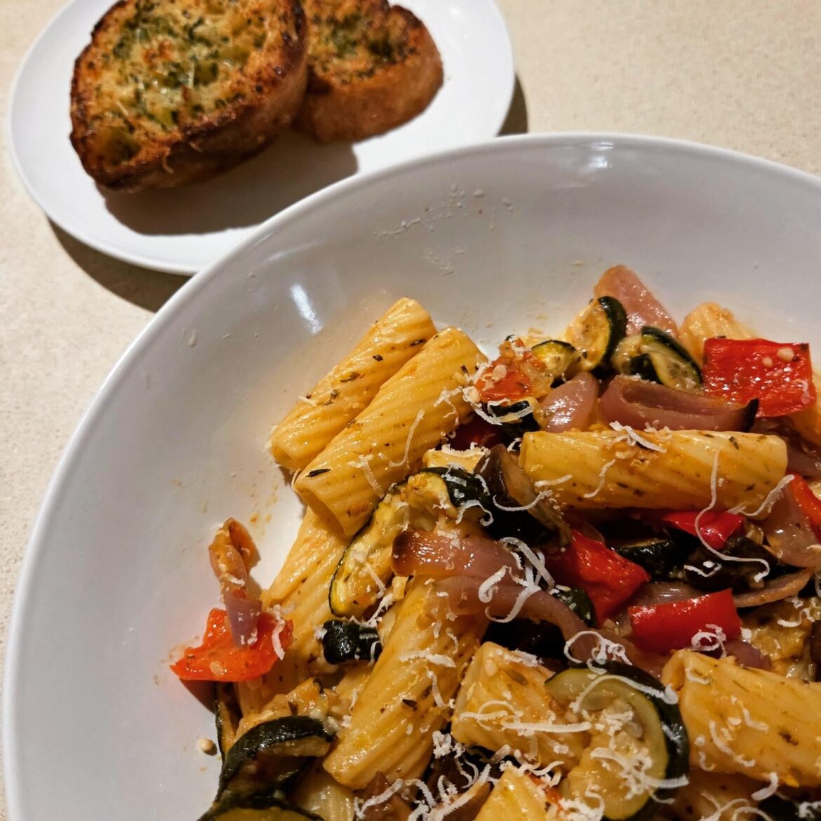 Homemade veggie pasta, and cheesy garlic sourdough.