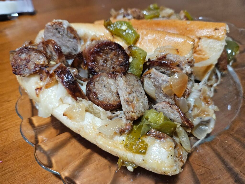Italian sausage, peppers, and onions sandwich with sharp provolone