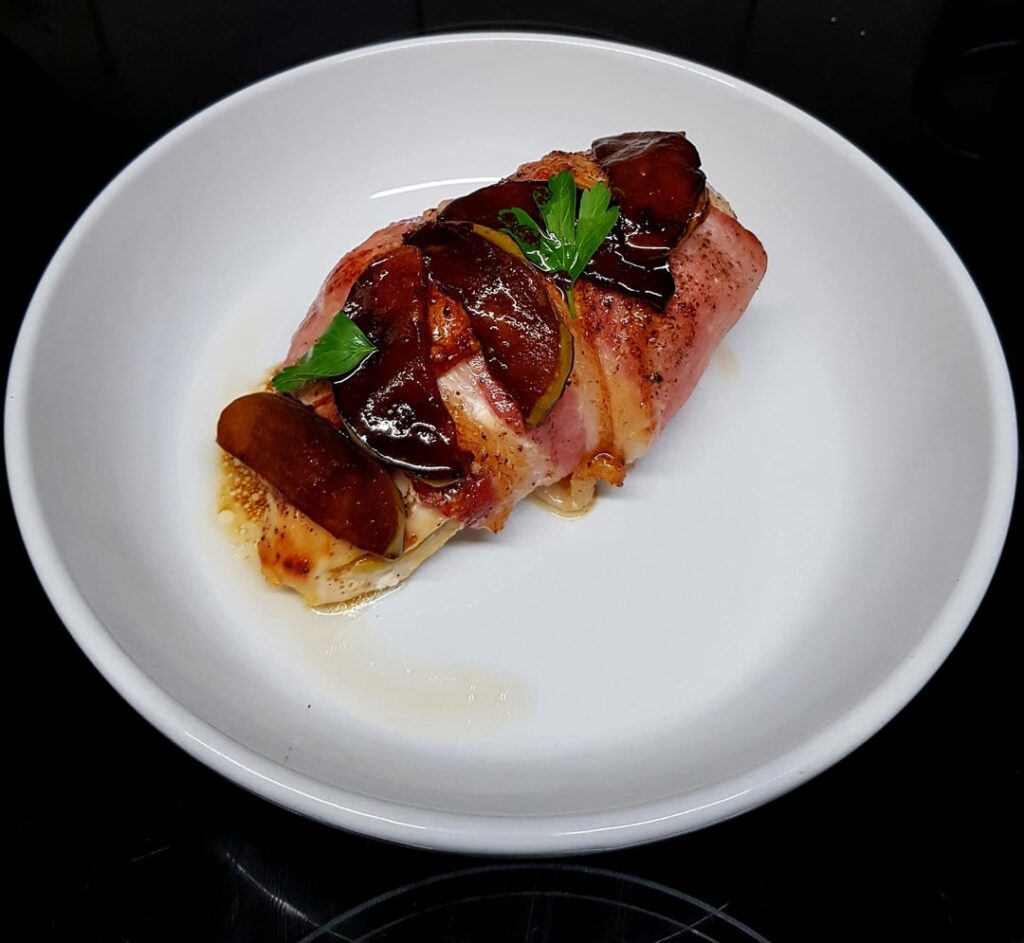 Apple and Cheese Stuffed Chicken, Wrapped in Bacon and Topped with Caramelised Apples, Potato Gratin and Garlic Butter Green Beans.