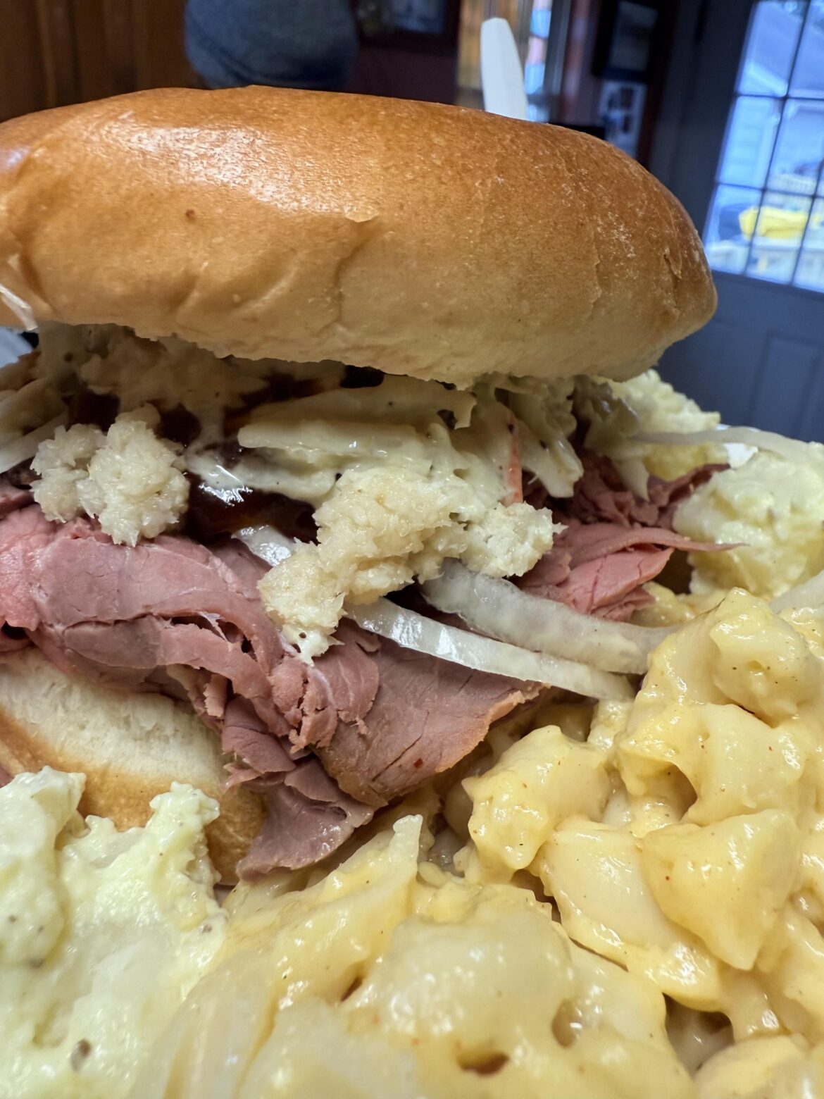 Maryland Pit Beef sandwich, with horseradish, coleslaw and BBQ sauce on top