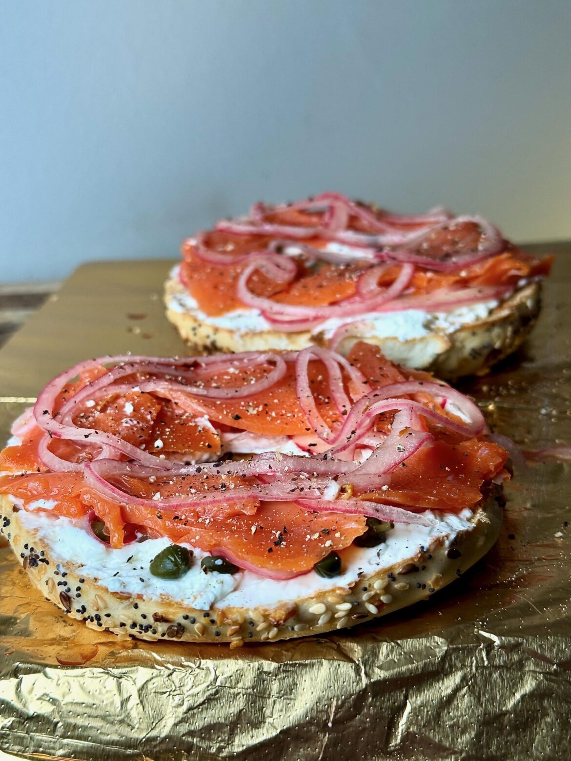 [homemade] Nova lox with capers, whipped cream cheese, pickled shallots and everything bagel from Gabriel's Bakery (PDX).