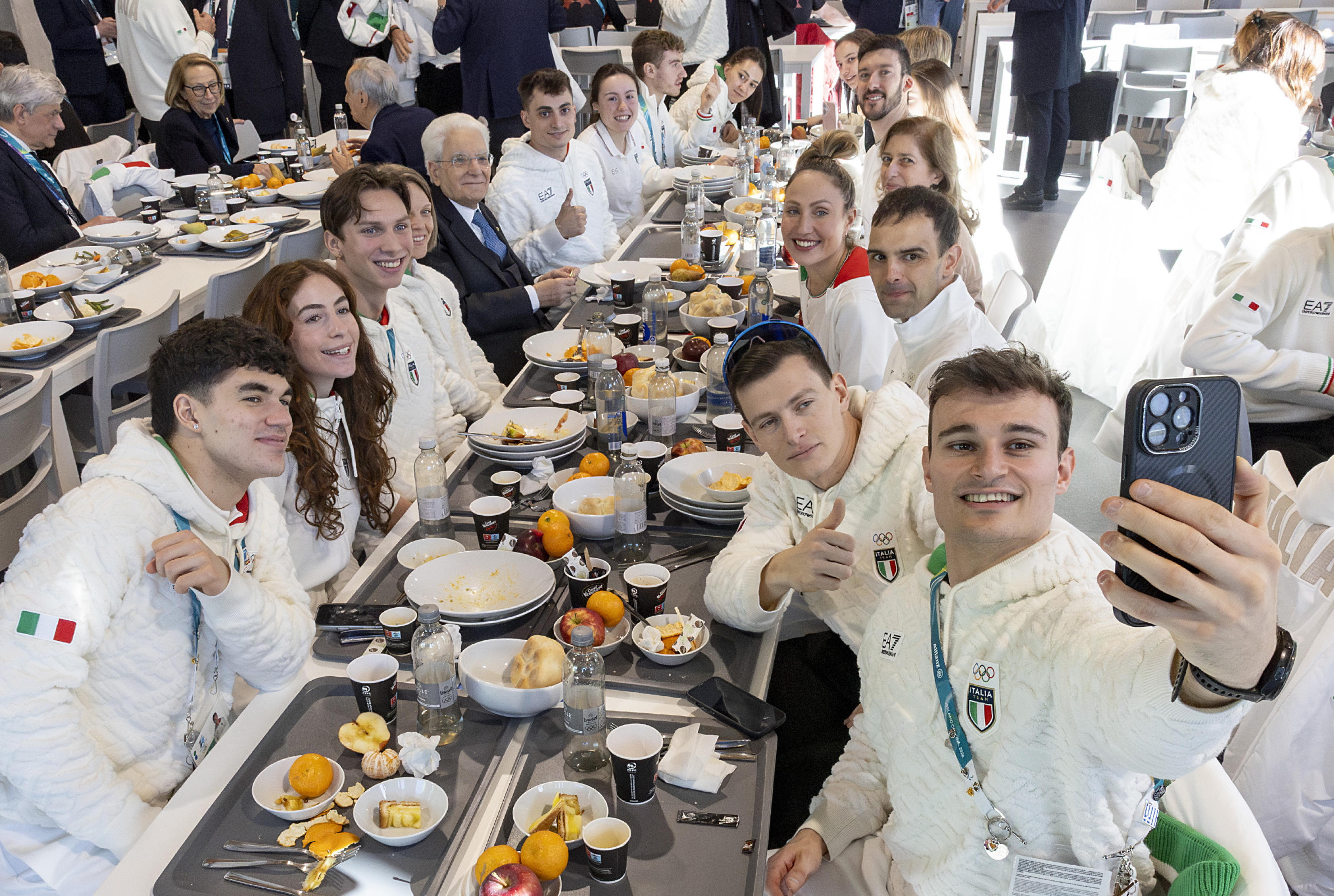 Italy's President Sergio Mattarella eating with Italian athletes in Milan.