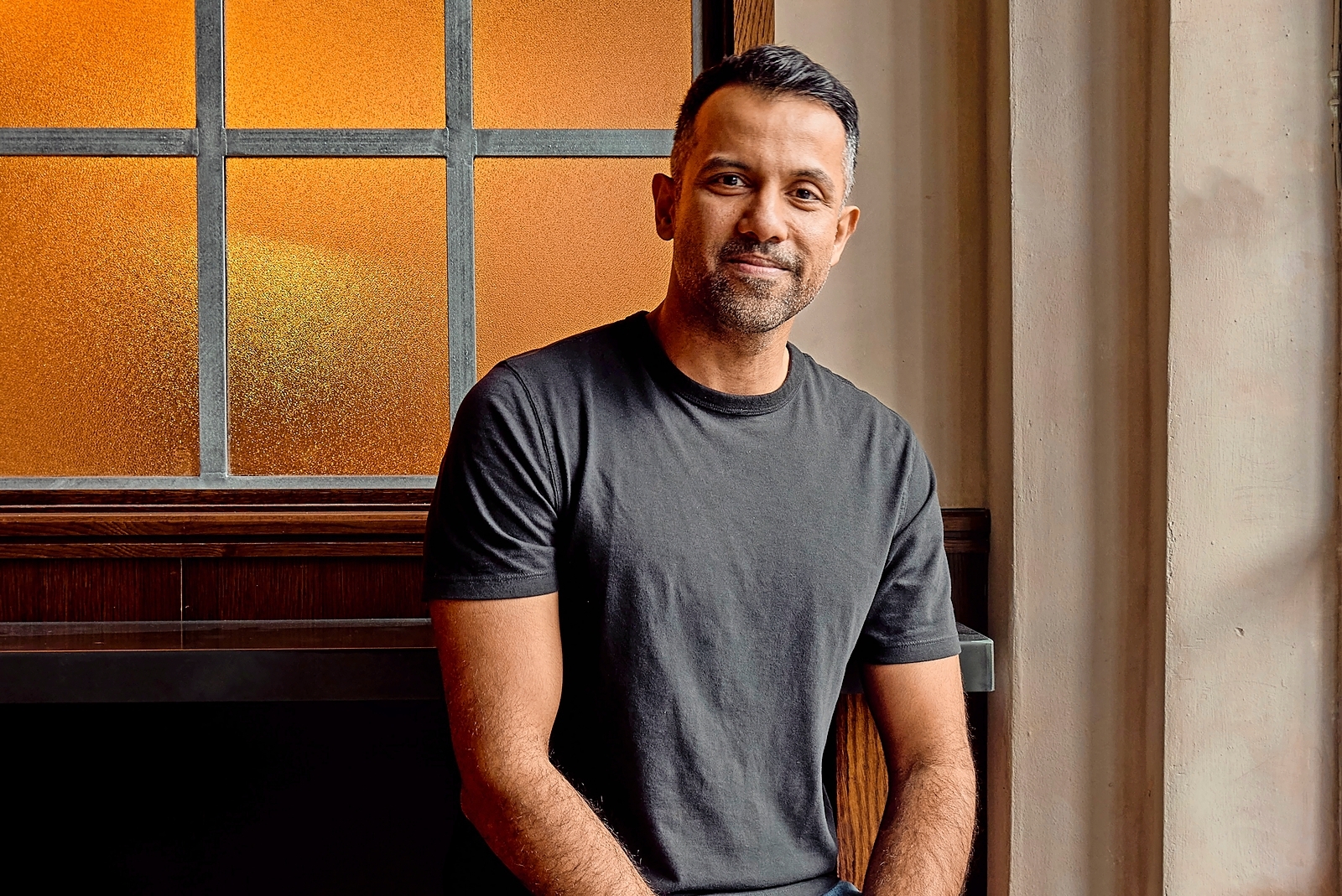 Karan Gokani, founder of Hoppers restaurant, sitting.