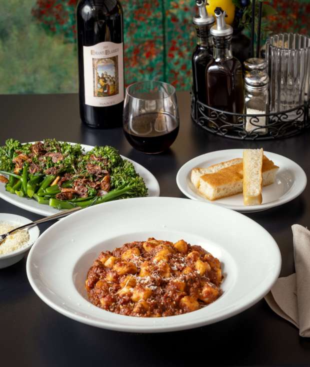 Gnocchi with Bolognese meat sauce, Broccolini alla bagna cauda and homemade focaccia bread on the creekside deck at Cafe Citti in Santa Rosa, Thursday, Feb. 22, 2024. (John Burgess / The Press Democrat)