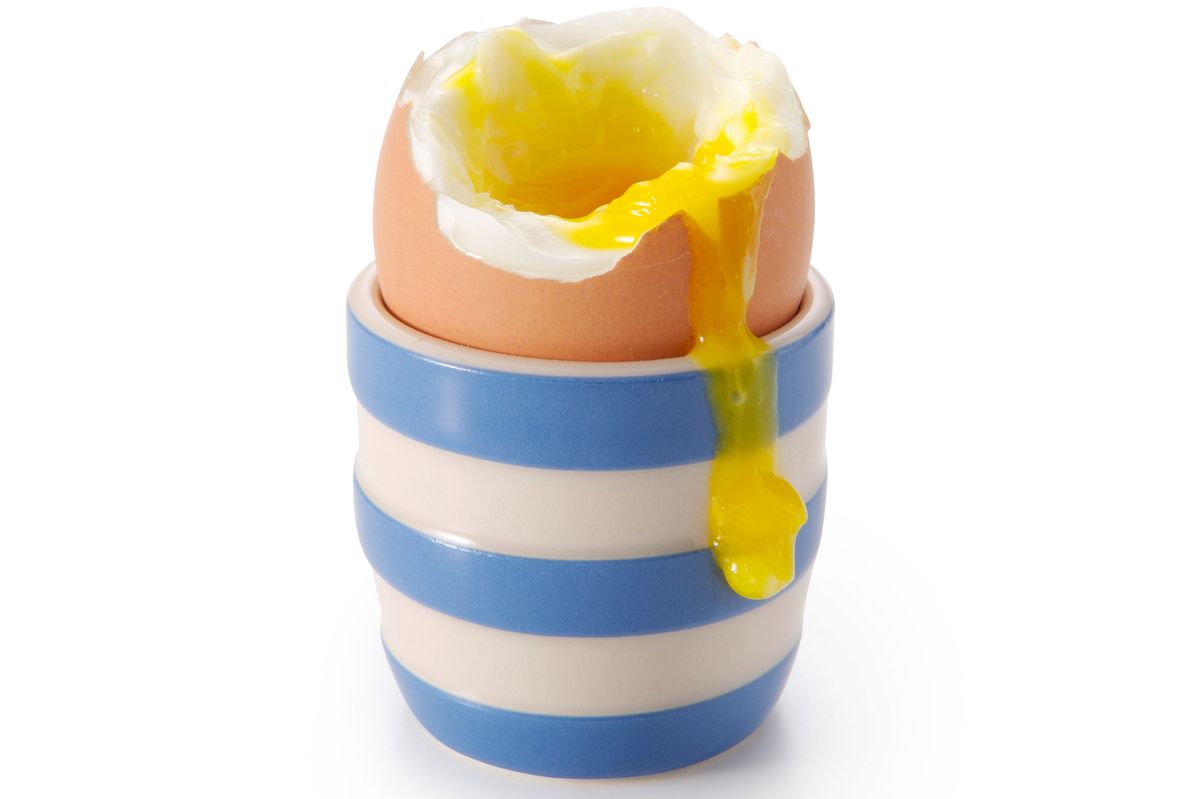 A boiled egg in a stripy blue egg cup