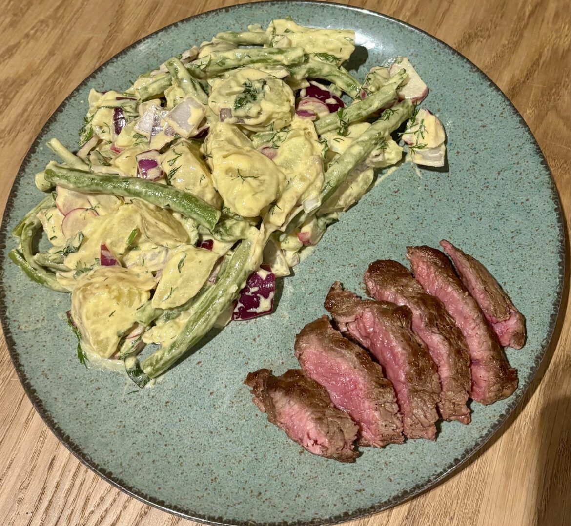 Medium rare steak with a potato green bean salade