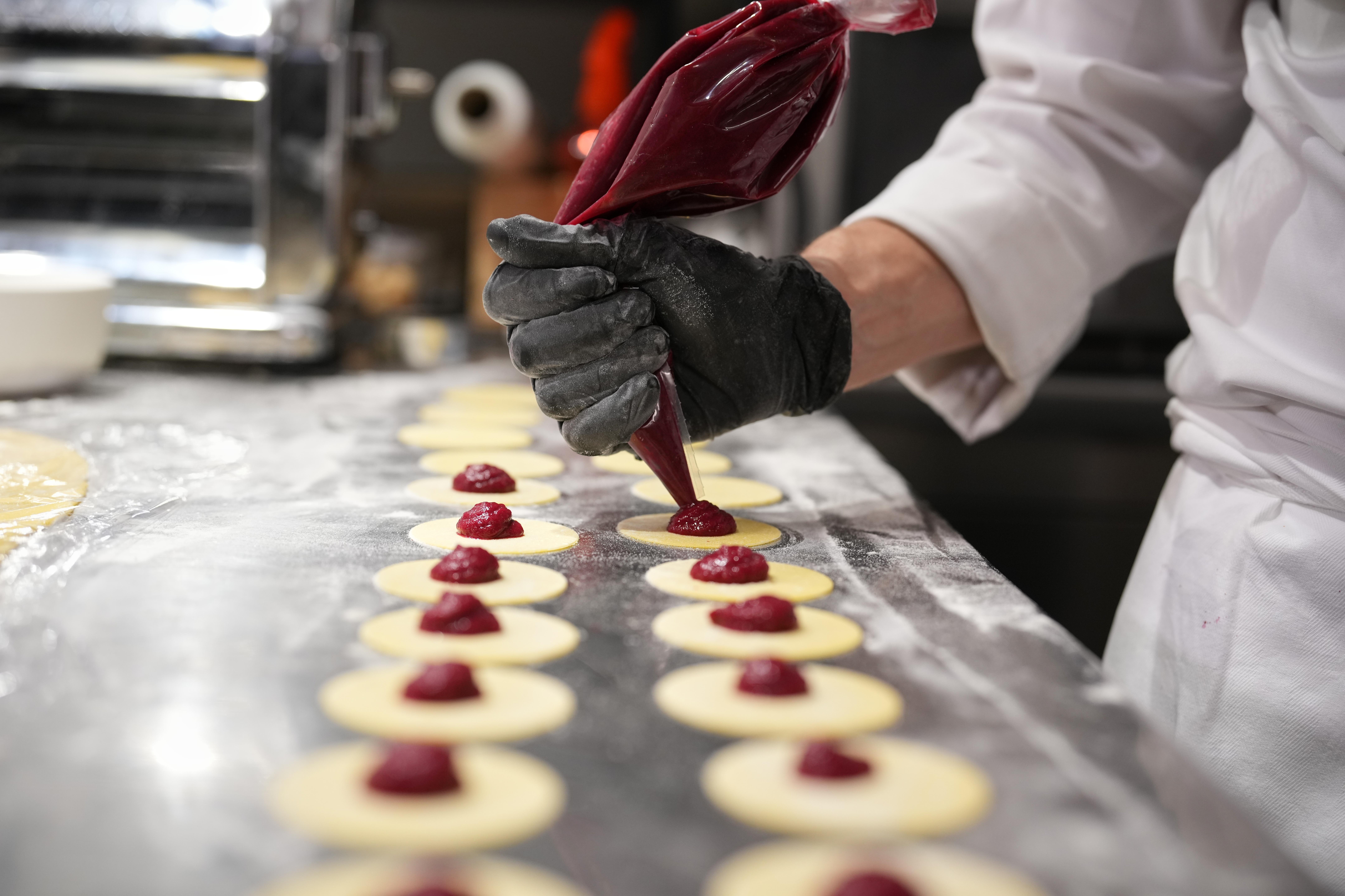 Local chef Gianluca Belli demonstrates how to make Casunziei, a...
