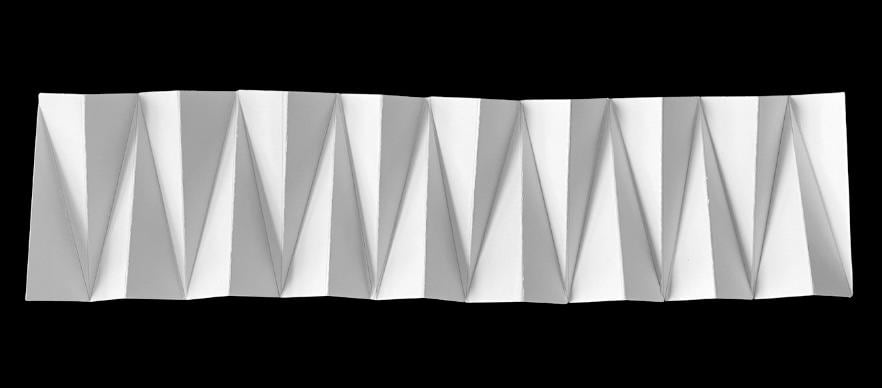 A strip of origami paper folded as an accordion with vertical and diagonal folds.