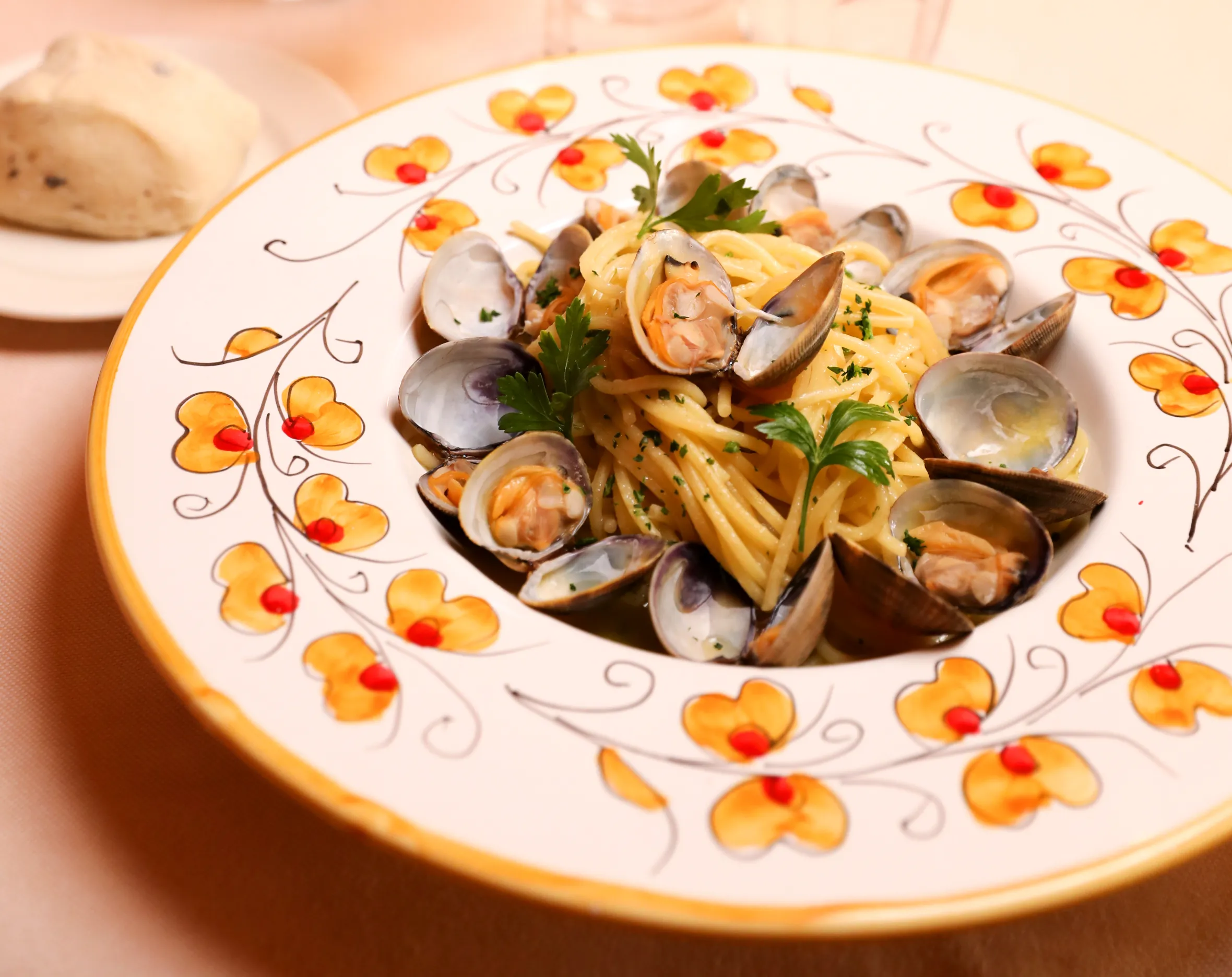Spaghetti and mussels in a painted bowl at Gina, Place Masséna — one of the best restaurants in Nice